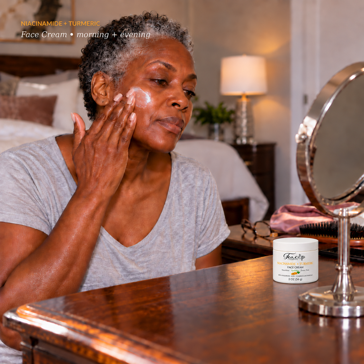 Mature Black woman applying Teacup Cosmetics Niacinamide + Turmeric Face Cream